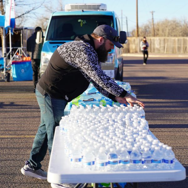 Volunteers setting up bottled waters for aid stations